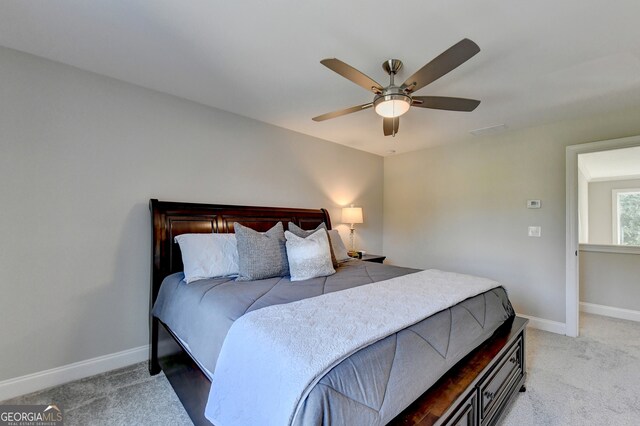 bedroom with light carpet and ceiling fan