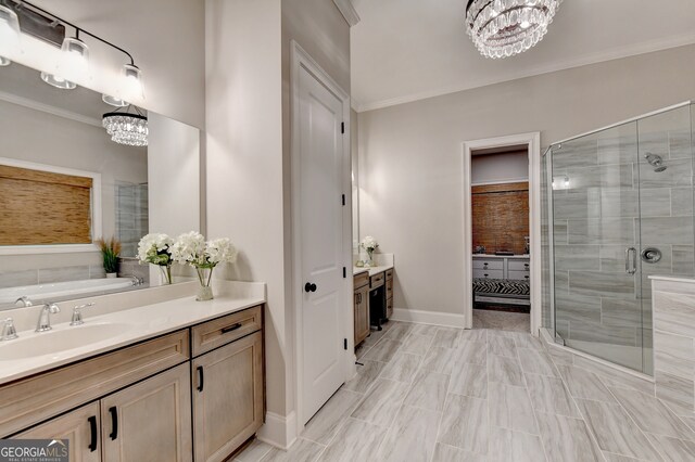 bathroom with vanity, independent shower and bath, a notable chandelier, and ornamental molding