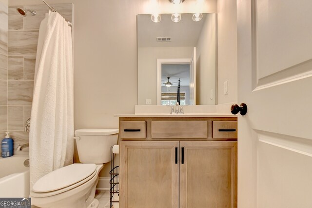 full bathroom with vanity, shower / bath combo with shower curtain, and toilet