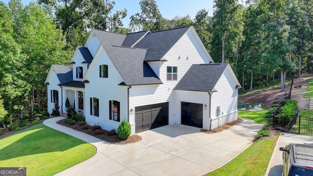 view of front of property with a front lawn and a garage