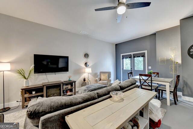 living room featuring concrete floors and ceiling fan