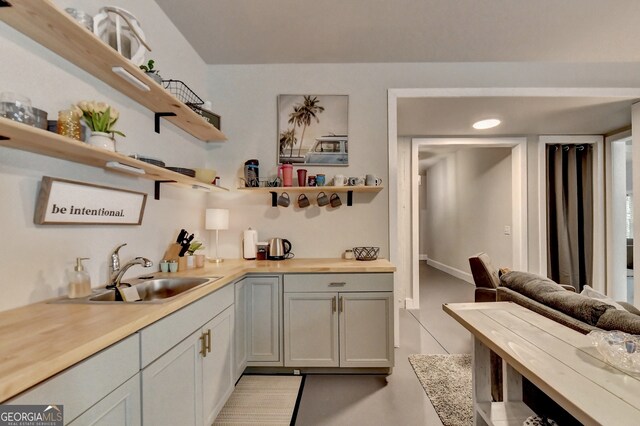 bar featuring sink and butcher block countertops