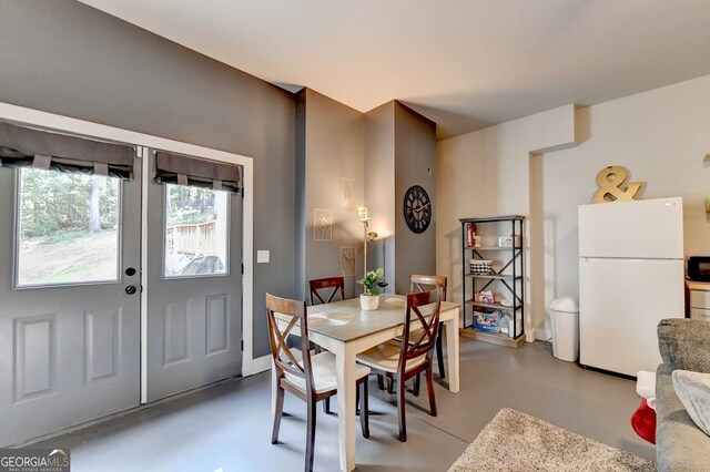 dining space featuring concrete flooring