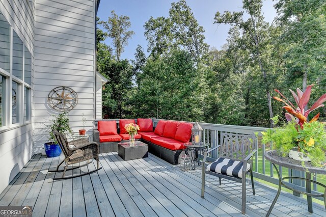 wooden terrace with an outdoor hangout area