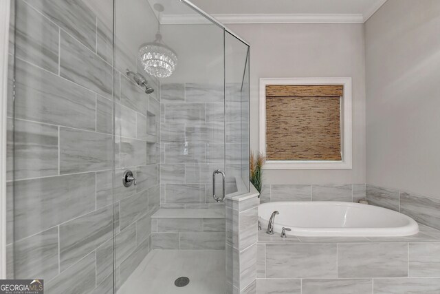 bathroom featuring independent shower and bath, an inviting chandelier, and ornamental molding