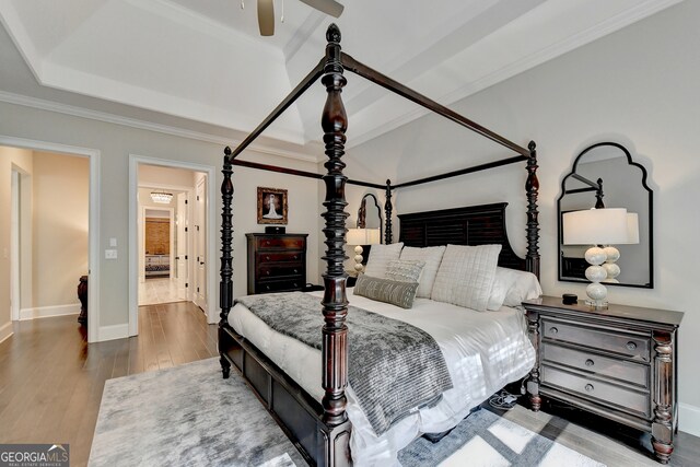 bedroom with hardwood / wood-style floors, crown molding, and ceiling fan