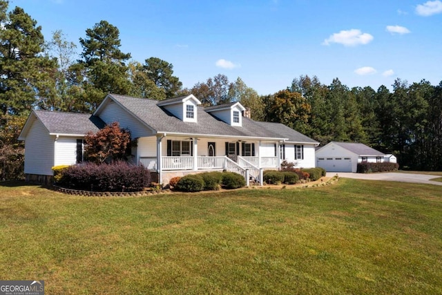 new england style home with a front yard, a garage, and a porch