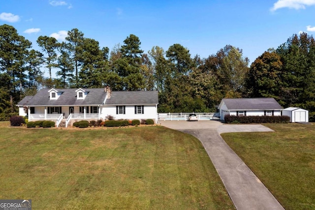 cape cod house with a front yard, a shed, and a porch