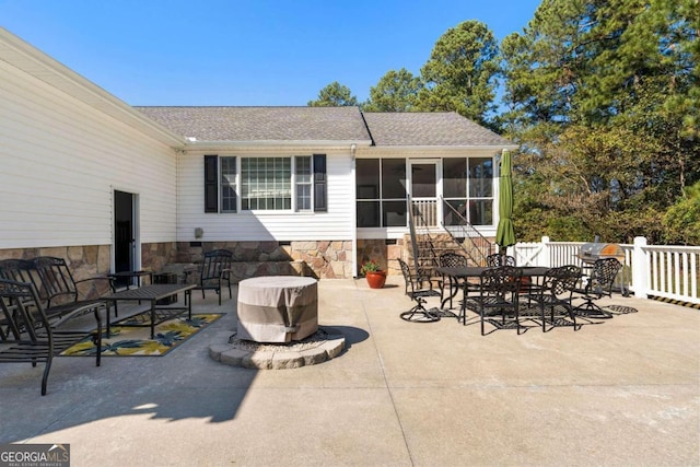 view of patio with a sunroom