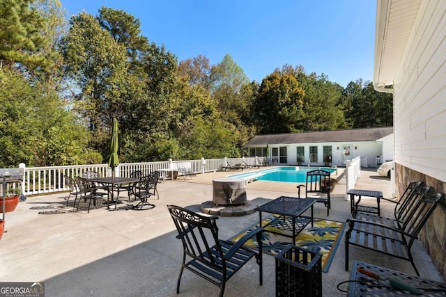 view of patio featuring a fenced in pool and an outbuilding