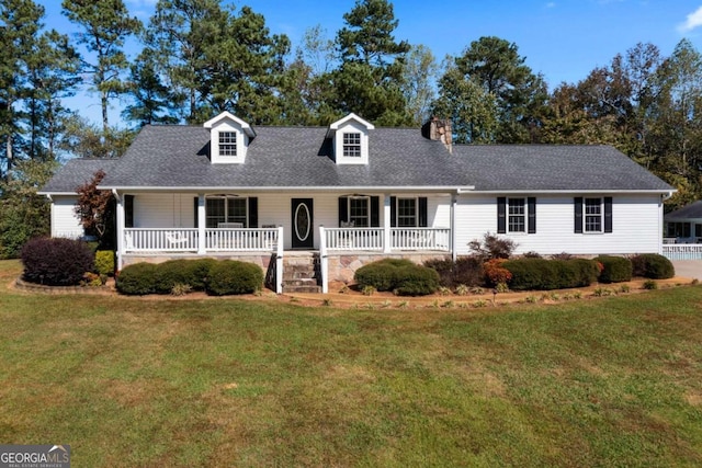 cape cod home featuring a porch and a front lawn