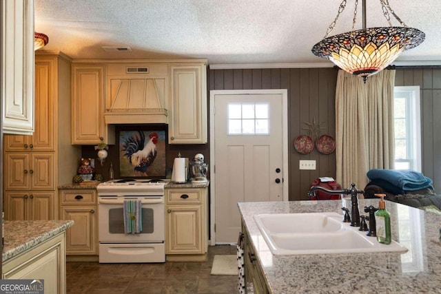 kitchen with premium range hood, cream cabinets, decorative light fixtures, and electric range