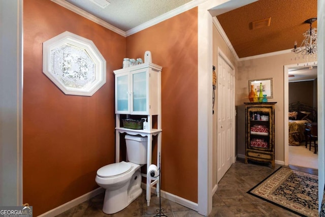 bathroom featuring a textured ceiling, a chandelier, toilet, ornamental molding, and tile patterned flooring