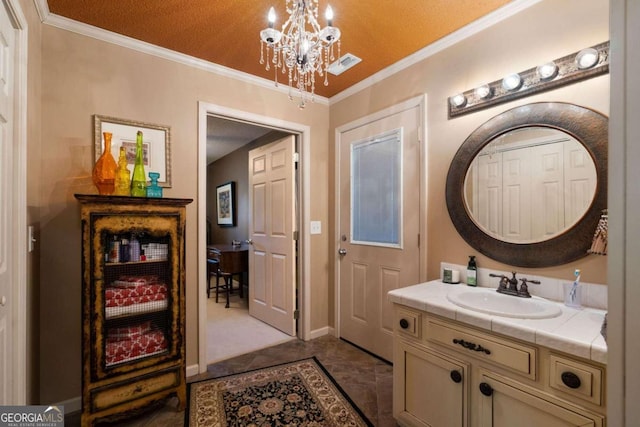 bathroom with vanity, crown molding, a textured ceiling, and a chandelier