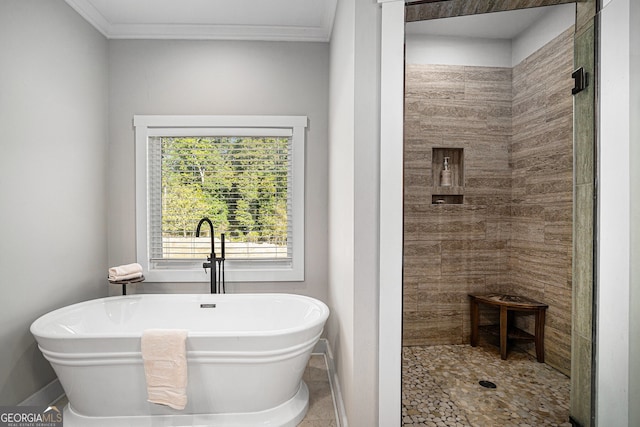 bathroom with ornamental molding and independent shower and bath