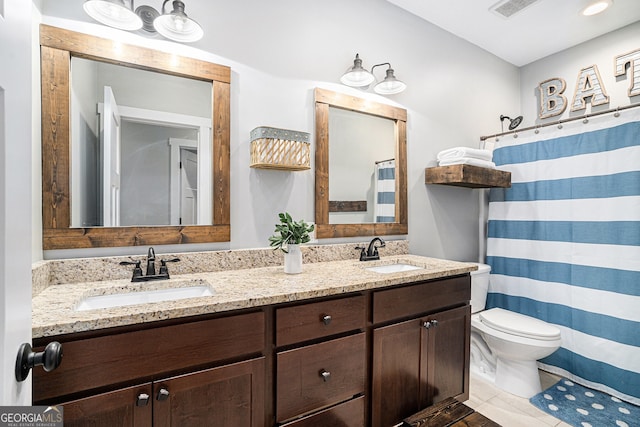 bathroom with vanity, toilet, curtained shower, and tile patterned flooring