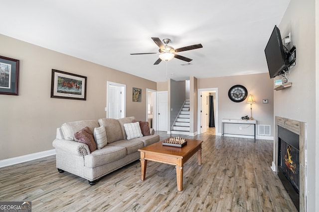 living room with ceiling fan and light wood-type flooring