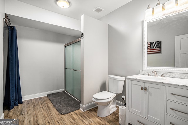 bathroom featuring toilet, hardwood / wood-style floors, and walk in shower