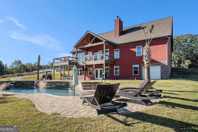 rear view of property with a wooden deck, a patio area, and a lawn