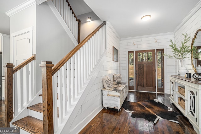 entrance foyer featuring crown molding, wood walls, and dark hardwood / wood-style flooring