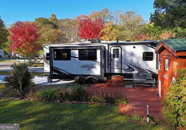 exterior space featuring a deck and a lawn