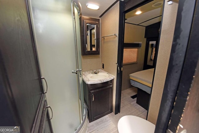 bathroom featuring vanity, a shower with shower door, wood-type flooring, and toilet