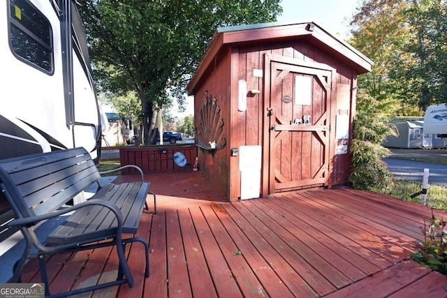 wooden terrace featuring a shed