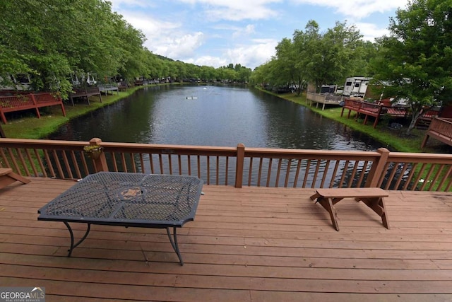 wooden terrace featuring a water view