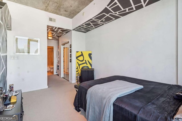 carpeted bedroom featuring washer / clothes dryer