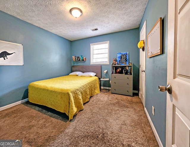 carpeted bedroom with a textured ceiling