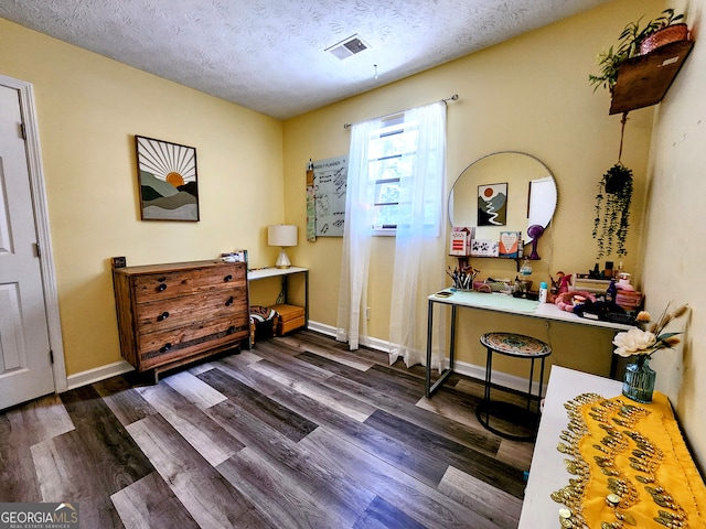 interior space with dark hardwood / wood-style flooring and a textured ceiling