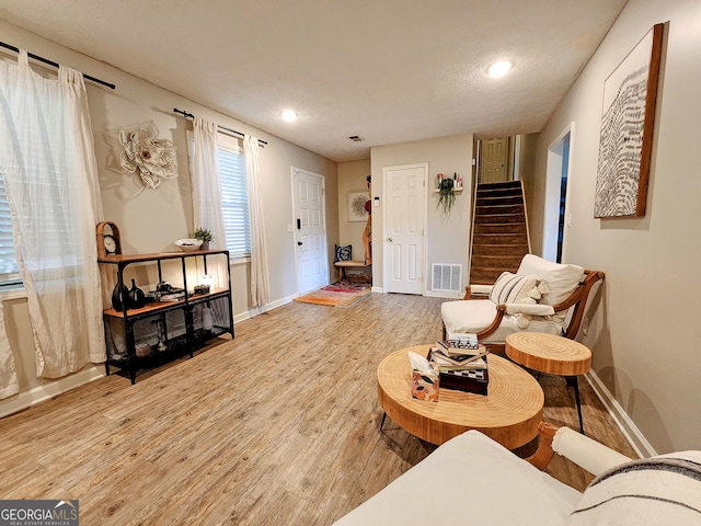 living room featuring hardwood / wood-style floors and a textured ceiling