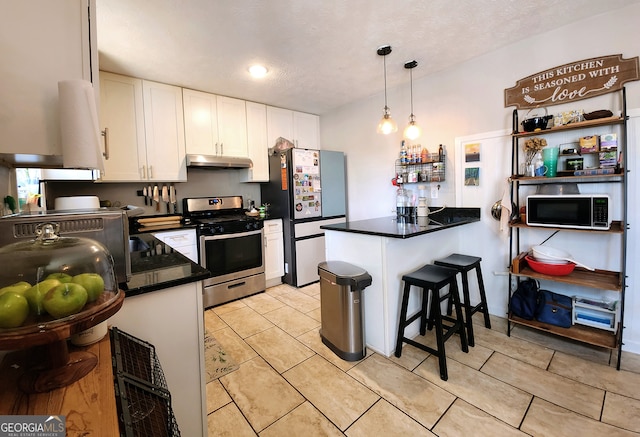 kitchen featuring white cabinetry, appliances with stainless steel finishes, hanging light fixtures, a breakfast bar, and kitchen peninsula