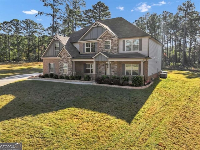 craftsman-style home with central air condition unit and a front lawn