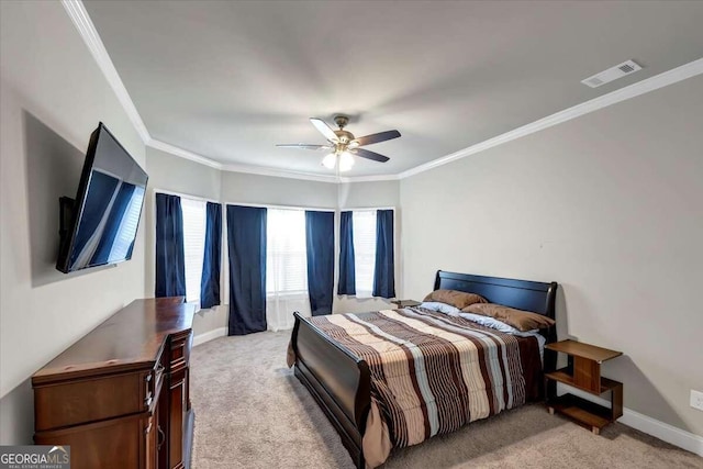 carpeted bedroom featuring ornamental molding and ceiling fan