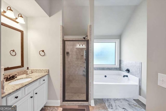 bathroom with vanity, lofted ceiling, and shower with separate bathtub