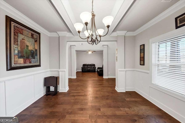 hallway featuring decorative columns, beamed ceiling, a notable chandelier, ornamental molding, and dark hardwood / wood-style floors