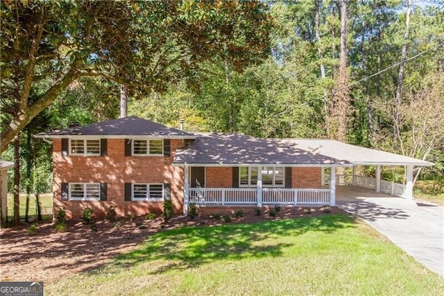 split level home featuring a carport and a front yard