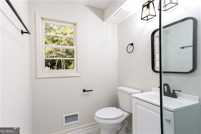 504 Milligan Dr, Stone Mountain, GA 30083 - bathroom with toilet, vanity, and baseboards