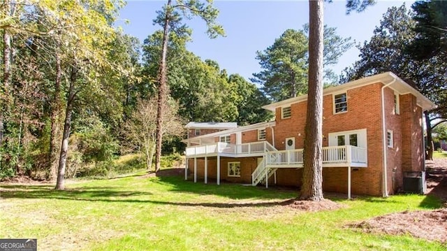 504 Milligan Dr, Stone Mountain, GA 30083 - back of house featuring stairs, a wooden deck, a yard, and brick siding
