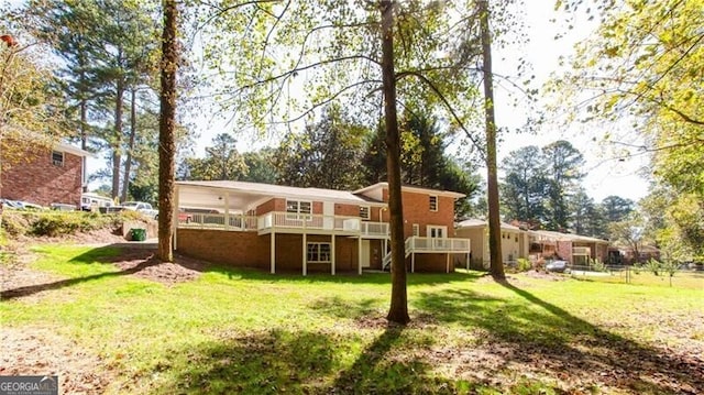 504 Milligan Dr, Stone Mountain, GA 30083 - rear view of property with a lawn and a wooden deck