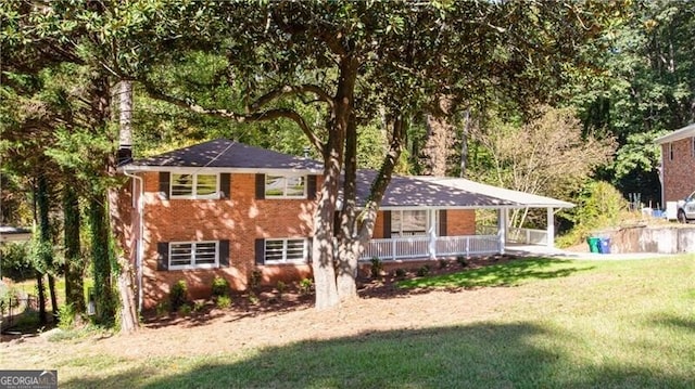 504 Milligan Dr, Stone Mountain, GA 30083 - split level home featuring a porch, a front lawn, and brick siding