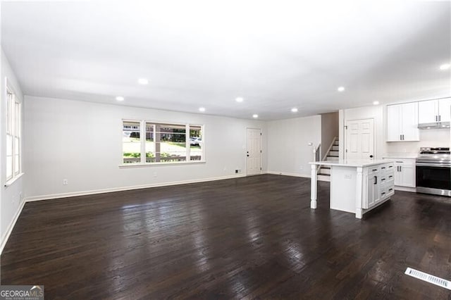 504 Milligan Dr, Stone Mountain, GA 30083 - unfurnished living room featuring recessed lighting, stairway, baseboards, and dark wood-type flooring