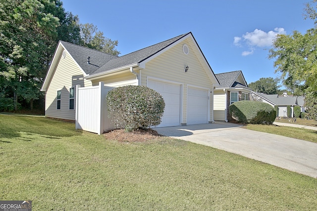 view of property exterior featuring a yard and a garage