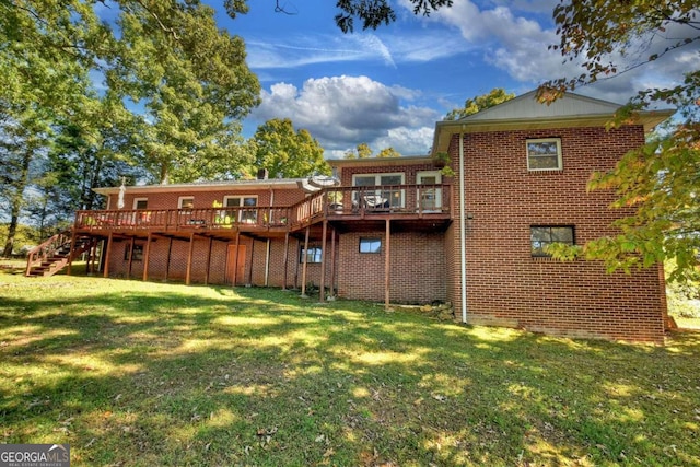 rear view of house with a yard and a wooden deck