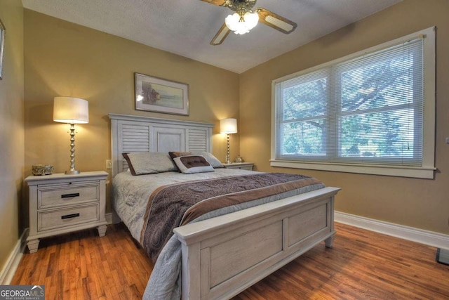 bedroom featuring ceiling fan and dark hardwood / wood-style flooring