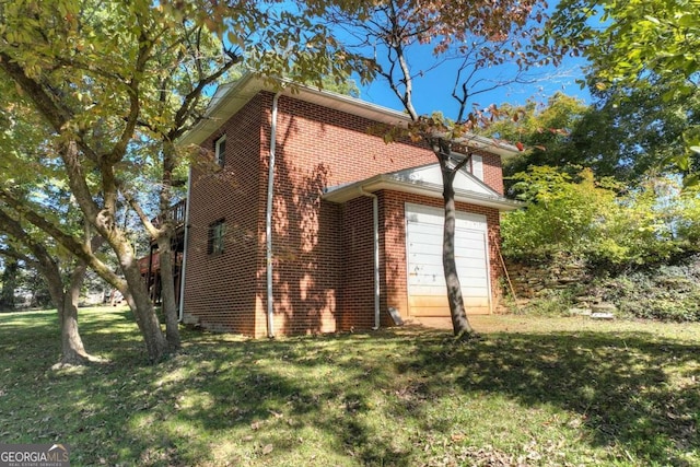 view of side of home featuring a lawn and a garage