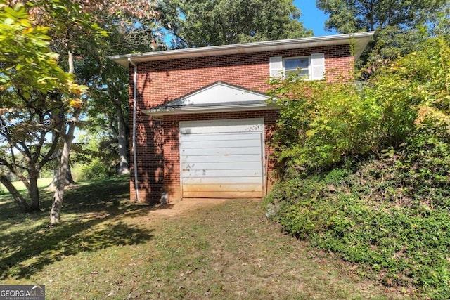 garage featuring a lawn