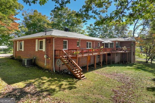 back of house featuring a wooden deck, central AC unit, and a lawn