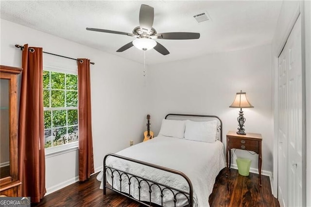 bedroom featuring ceiling fan, a closet, and dark hardwood / wood-style floors